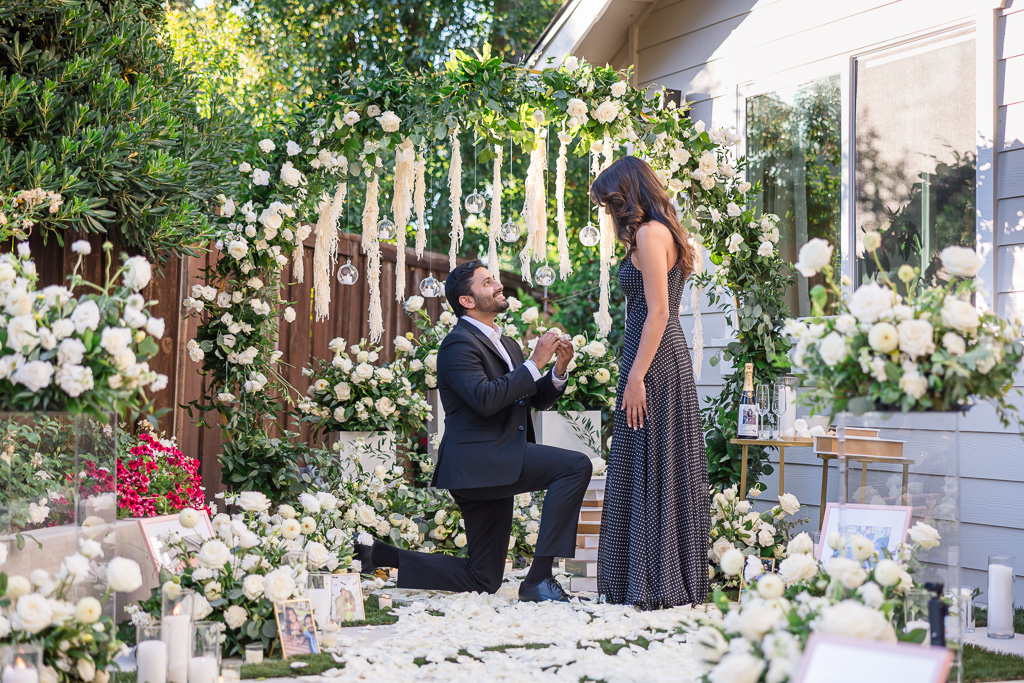 backyard marriage proposal with lush floral setup and decor