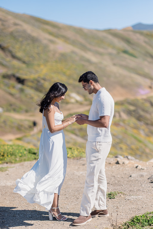 holding hands and putting on engagement ring after she said yes