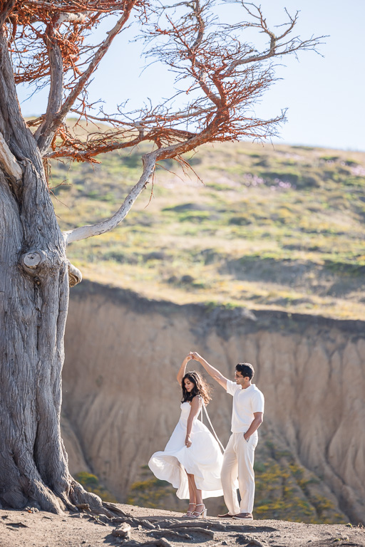Mori Point engagement photos dancing in the wind