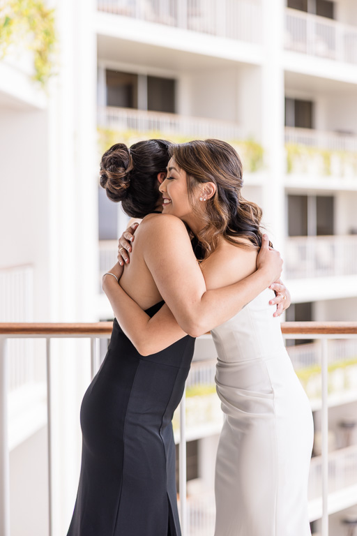 bride and bridesmaid hugging