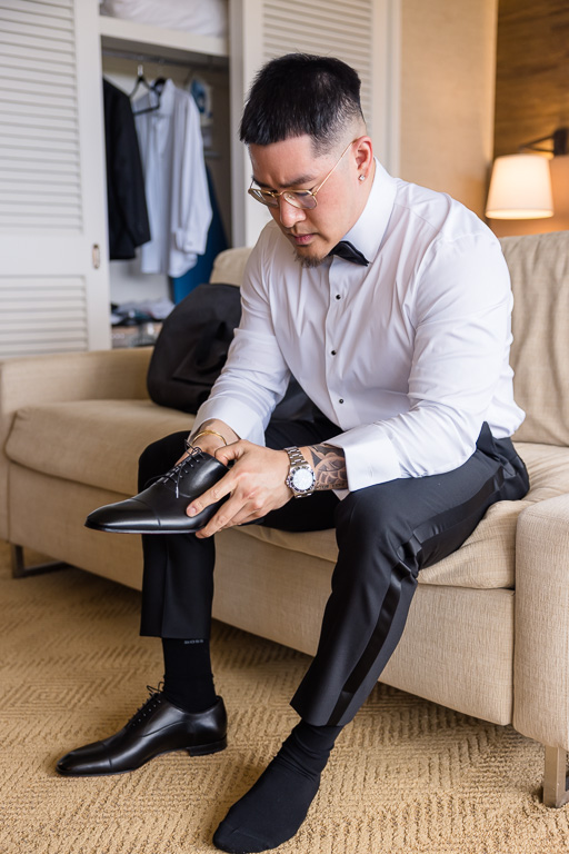 groom getting his shoes on