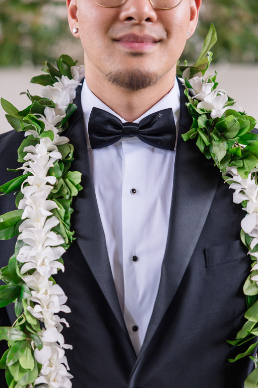 close-up of groom's tux, bow tie, and lei