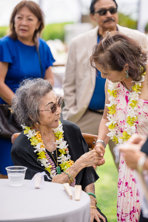 grandma sitting at a table greeting guests