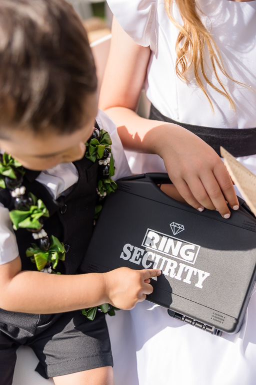 cute little ringbearer showing off his ring security box