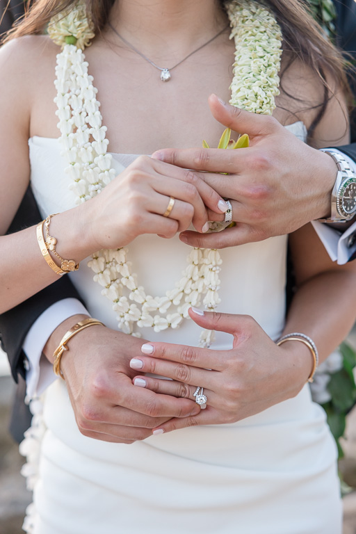 creative wedding photo showing bride and groom each putting on each other's wedding rings