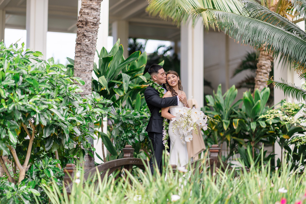 wedding day portrait of bride and groom in a tropical green setting