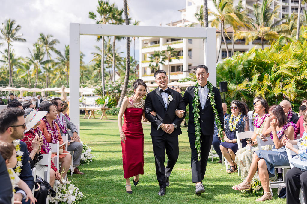 groom walking down the aisle with both of his parents