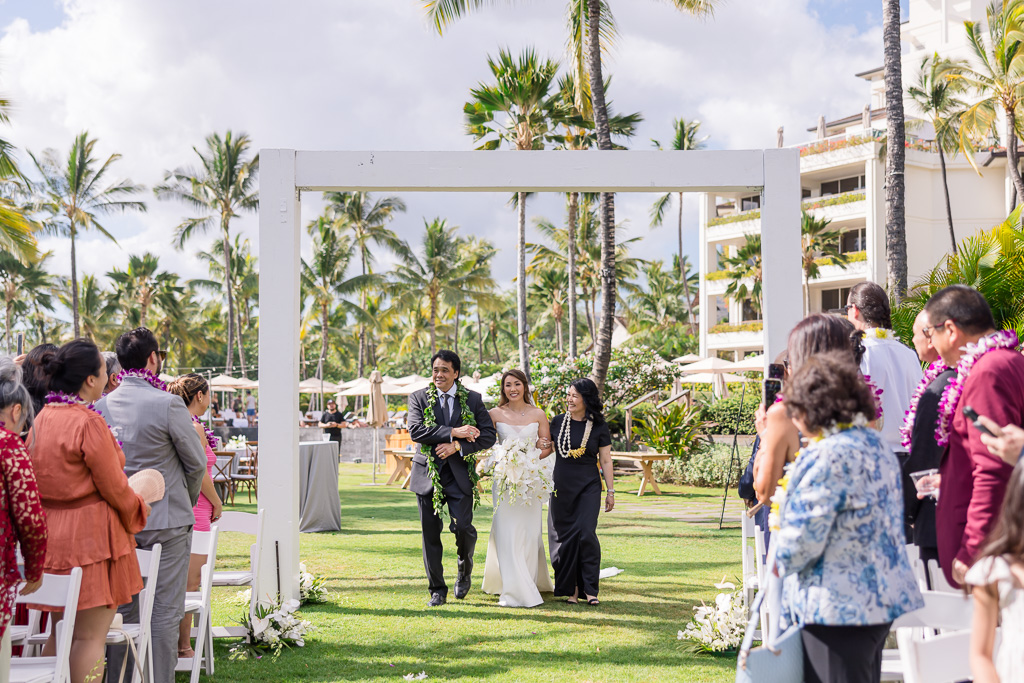 bride walking down the aisle with mom and dad