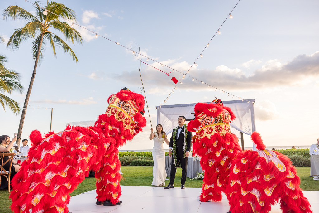 bride dangling a red pocket on the end of stick for the lions
