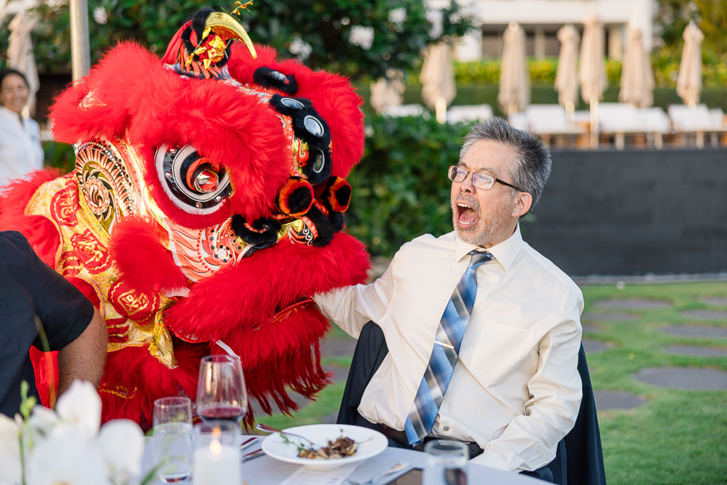lion dancer eating the arm of a guest