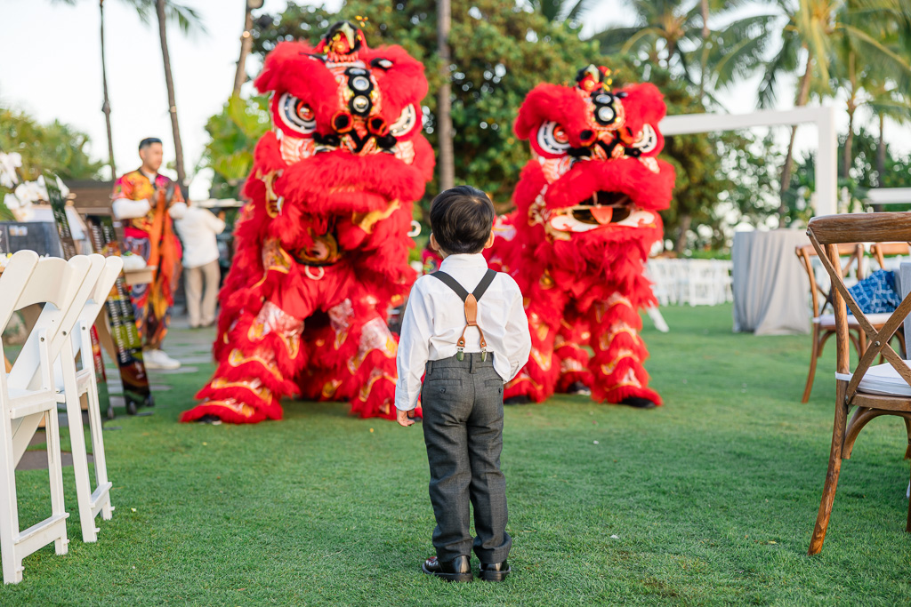 little boy enjoying the lion dance at a wedding