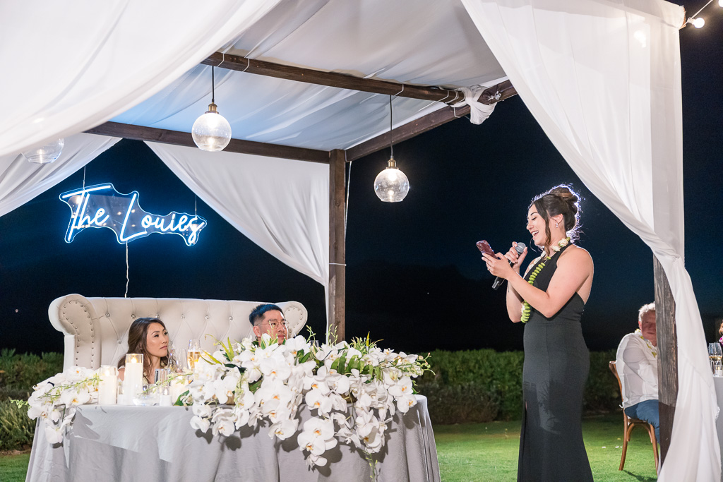 bridesmaid giving a dinner speech at night