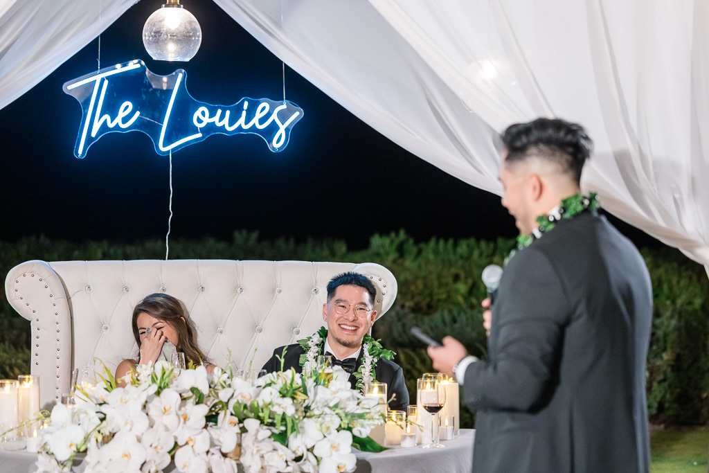 bride and groom laughing and crying at dinner toast