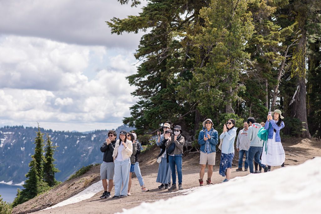 group of friends cheering and clapping for newly-engaged couple