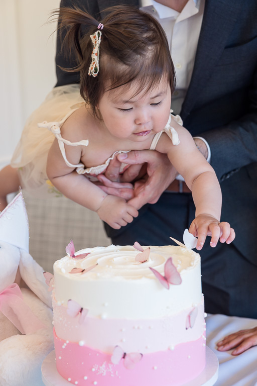 baby hovering over cake