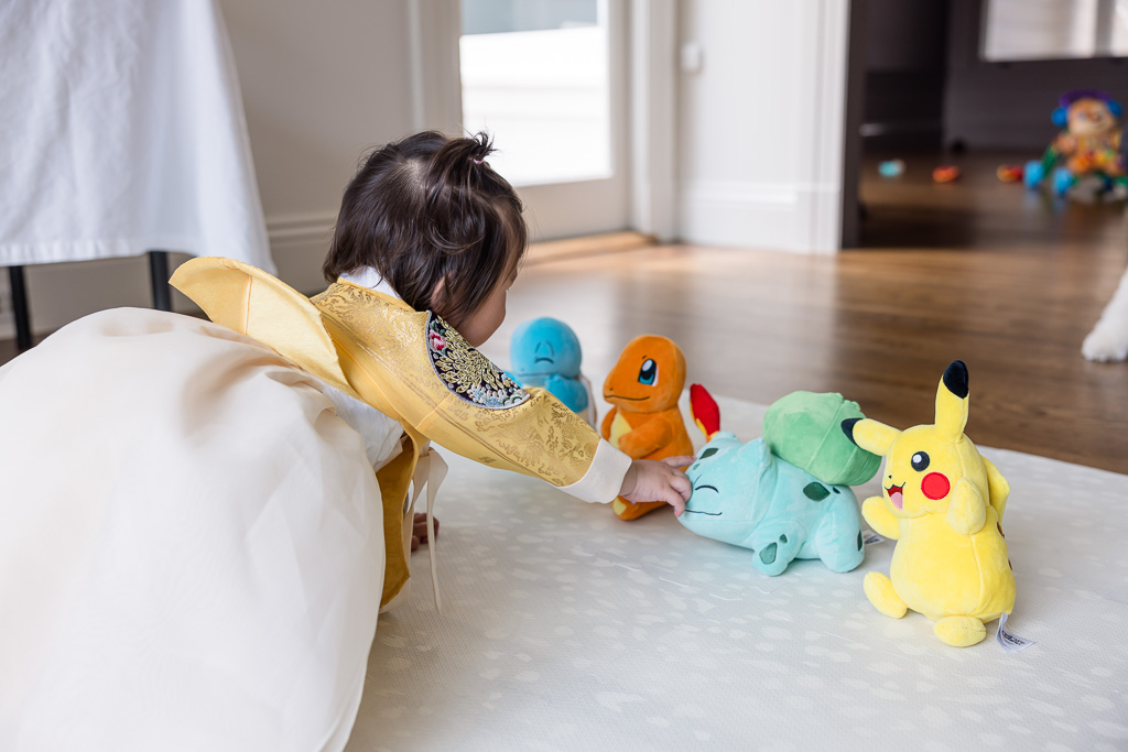 baby reaching for her starter pokemon