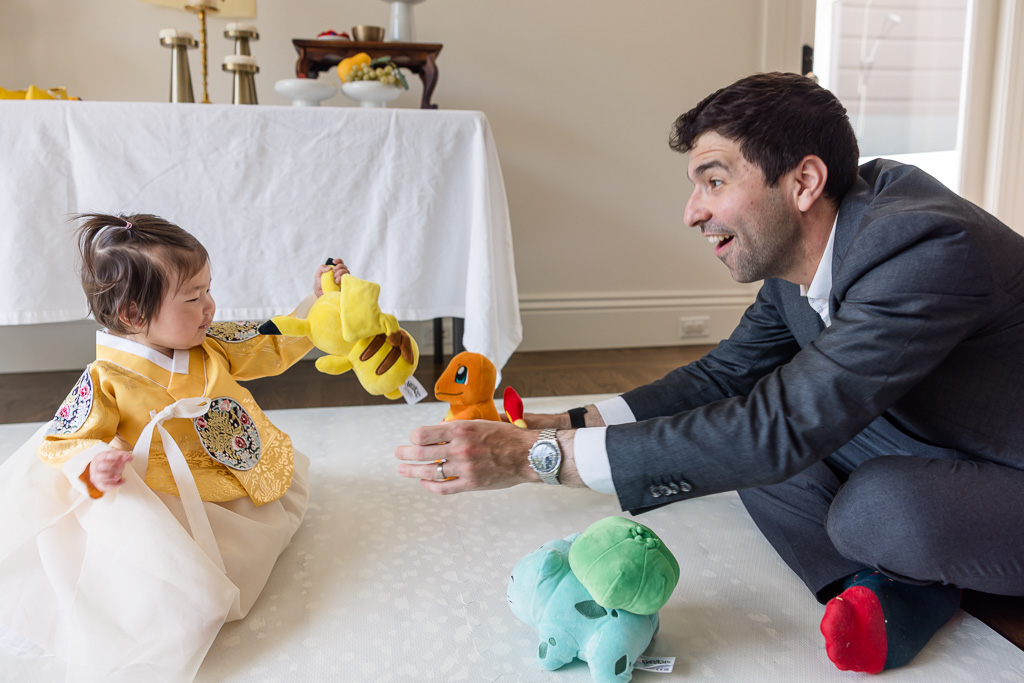 baby with Pikachu stuffed toy