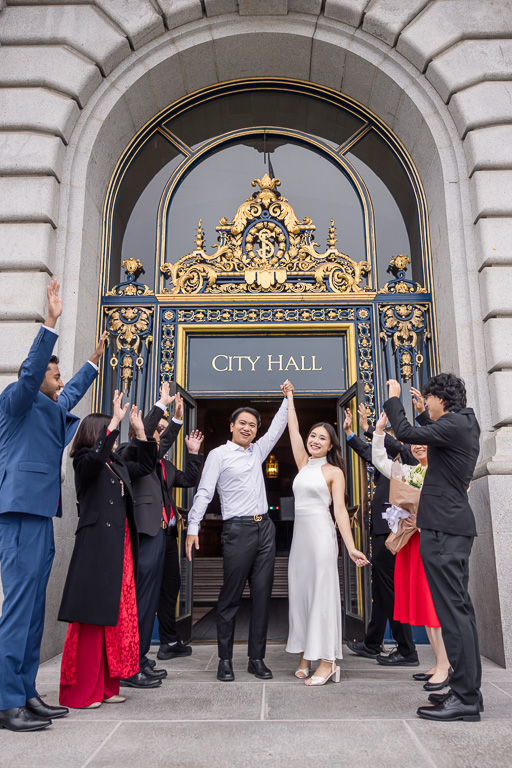 triumphantly marching out of the front door of City Hall after elopement