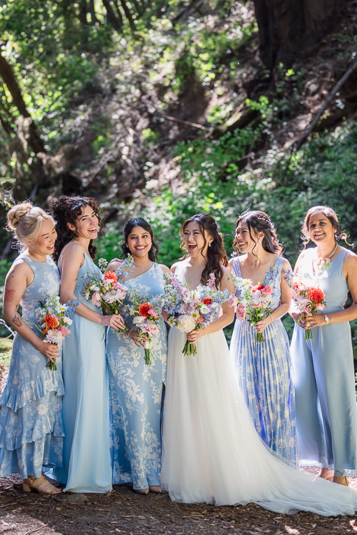 bride and her bridesmaids in the woods