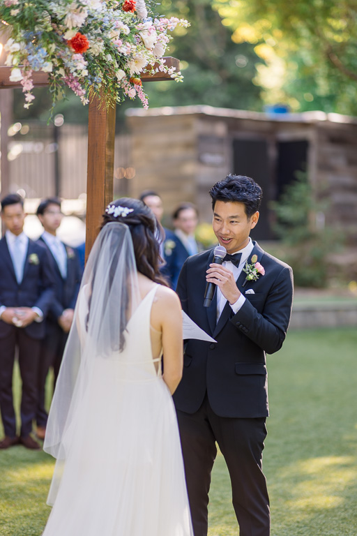 groom saying his vows to his bride during their intimate wedding ceremony