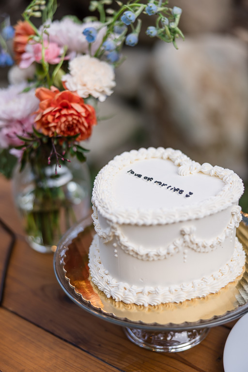 white wedding cake shaped like a heart