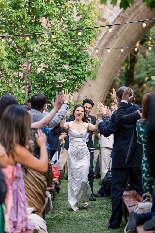outdoor wedding reception grand entrance running through long tables