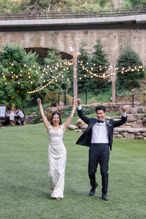 bride and groom cheering for being married