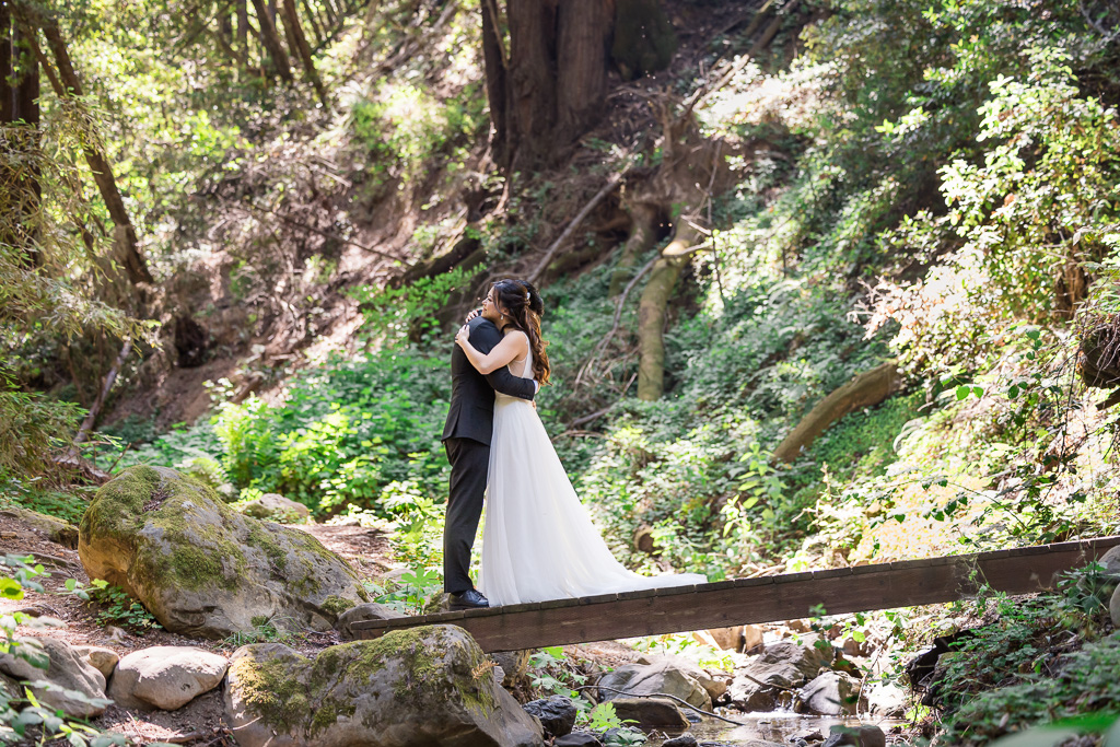 bride and groom on a wooden bridge