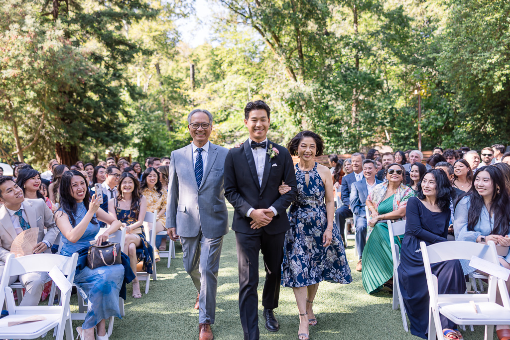 groom being escorted by his parents