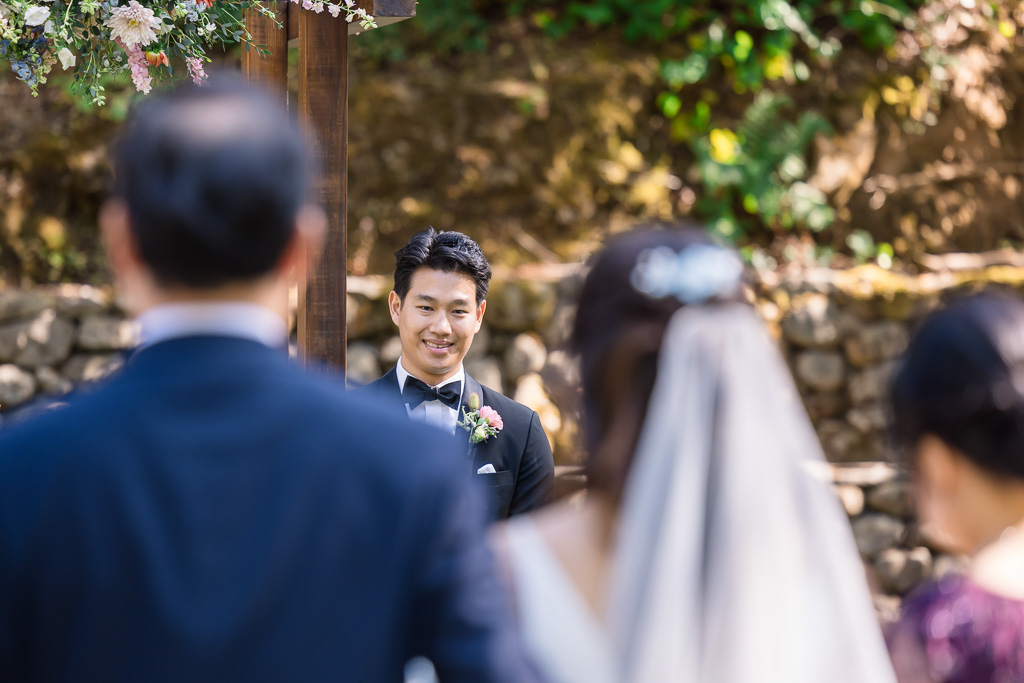groom looking at the bride the moment before she is handed off