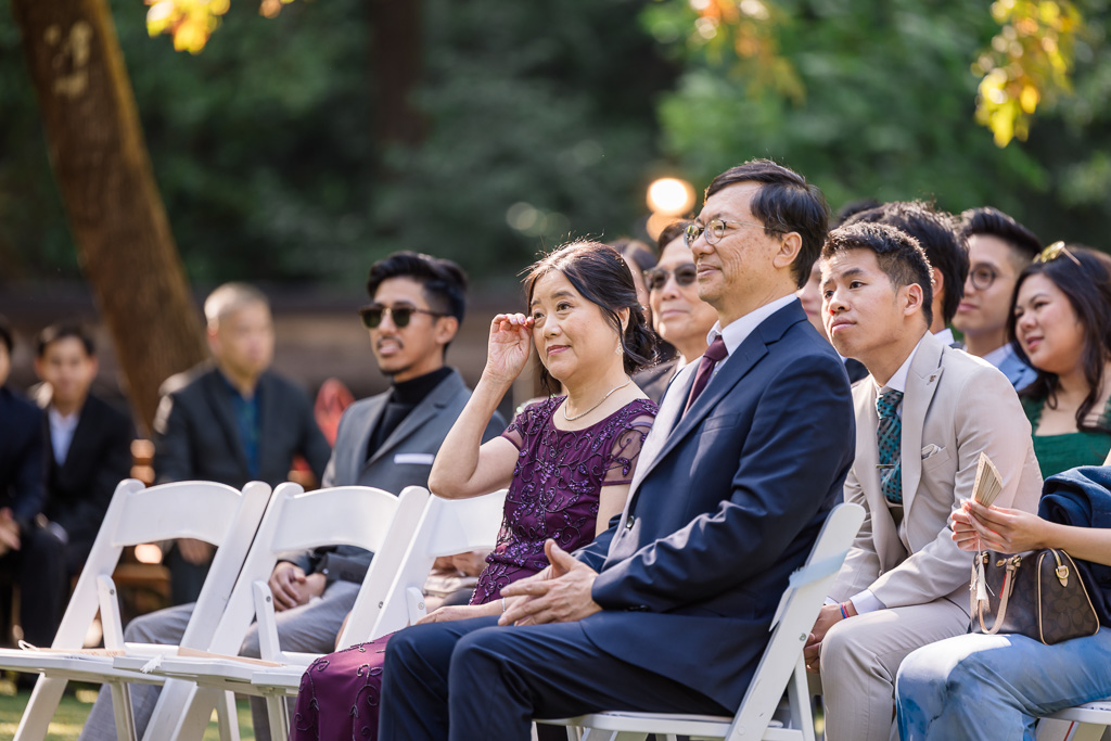 groom's parents having an emotional moment during the wedding ceremony