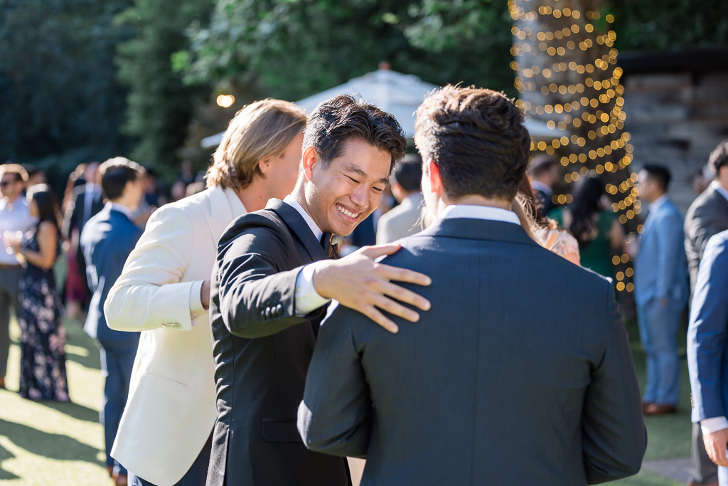 groom mingling with guests during cocktail hour