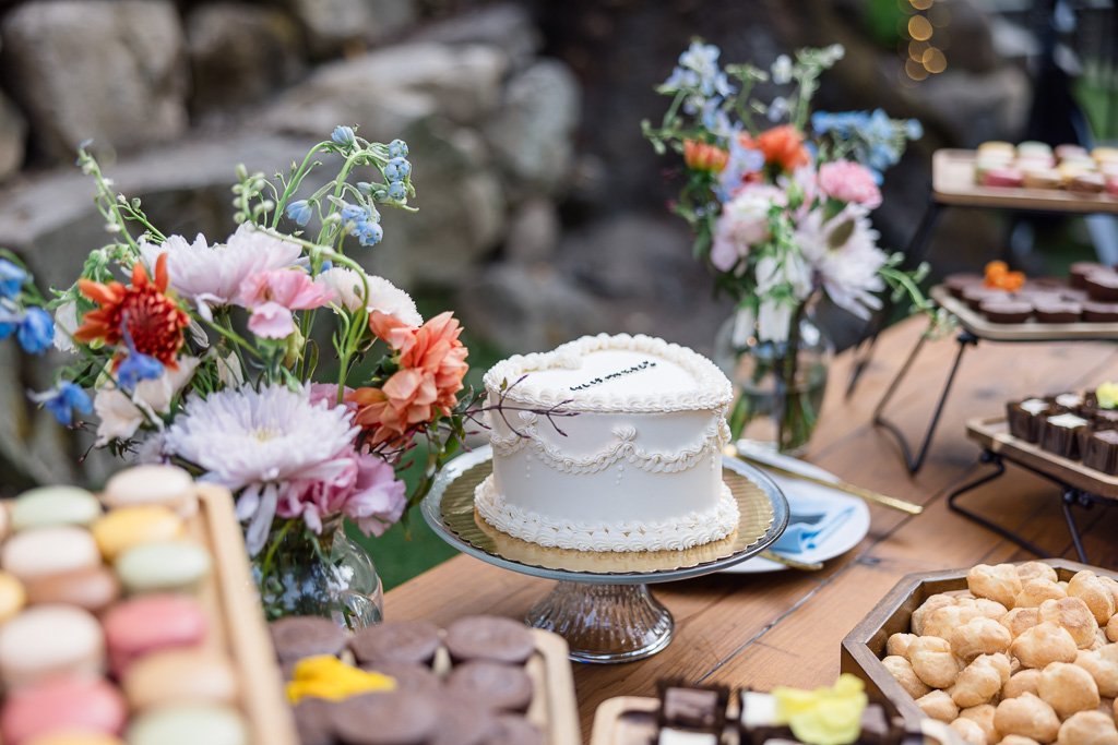 heart-shaped wedding cake on dessert table