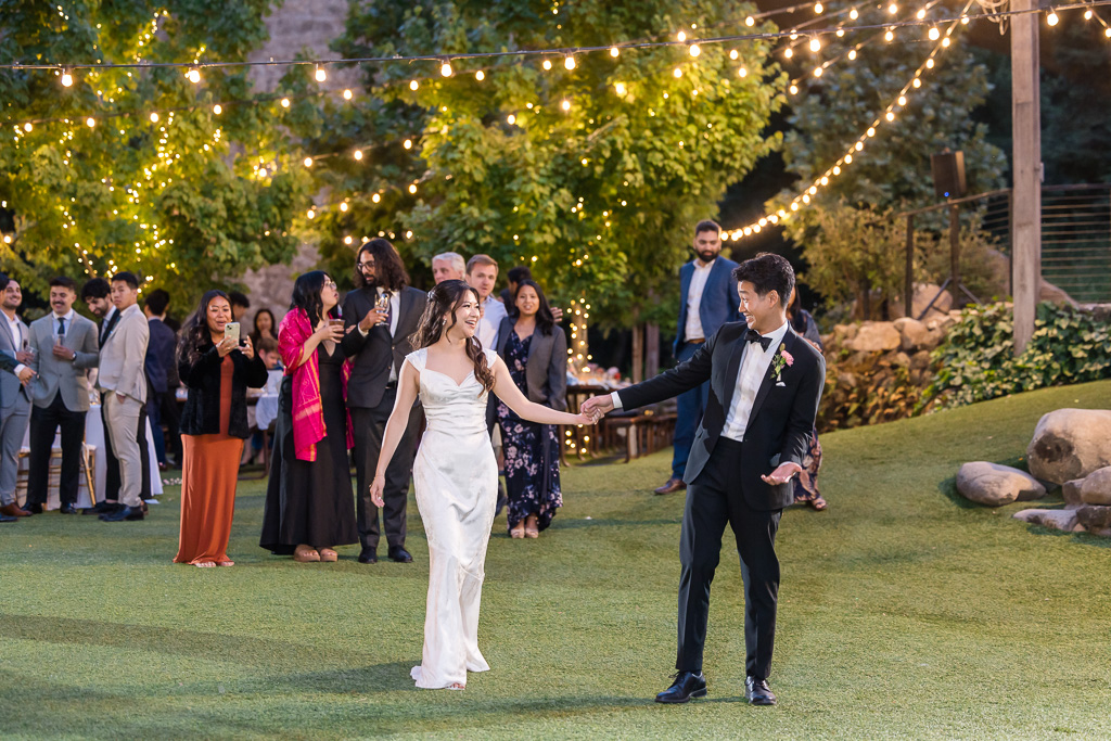entrance to the first dance with all of their guests standing in the background watching