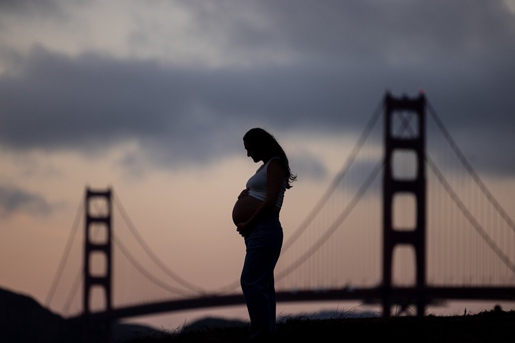 maternity photo silhouetted against the Golden Gate Bridge