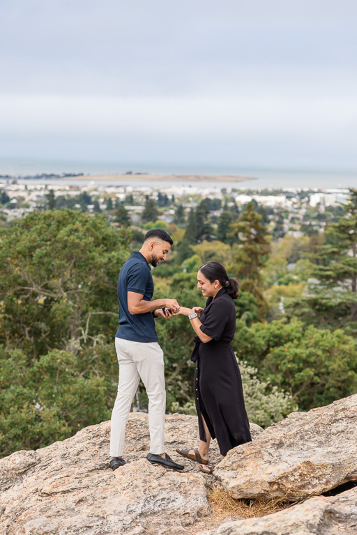 putting on the ring after proposing on a big rock