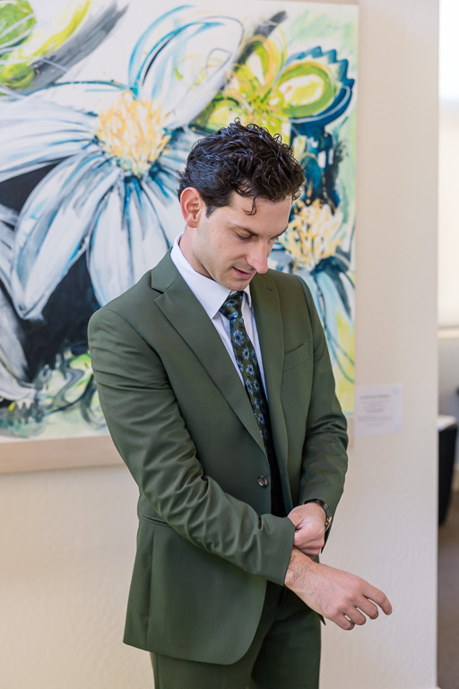 groom prep: adjusting sleeves and suit