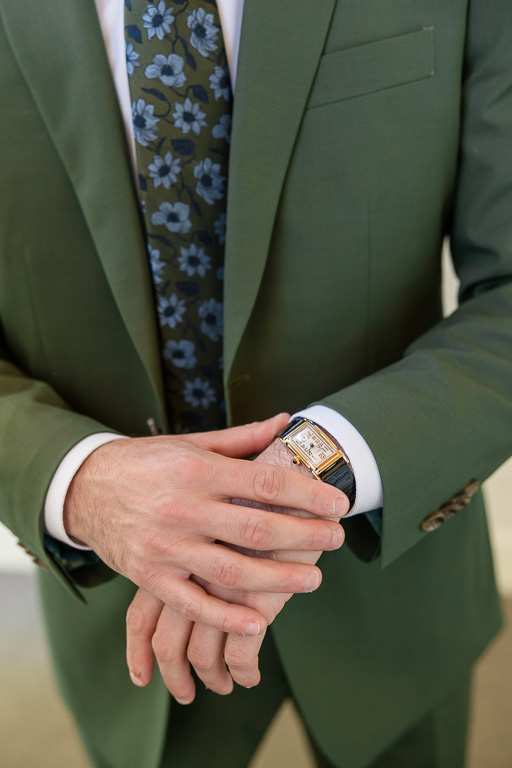 groom wearing his watch on wedding day