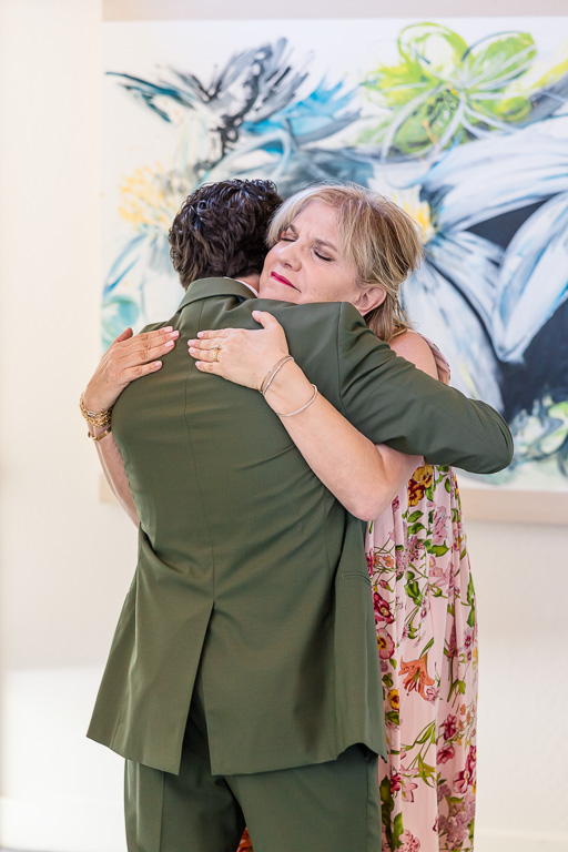 mother of groom giving son a hug just before wedding