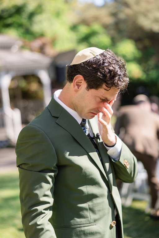 emotional moment of groom crying as his bride walks down the aisle
