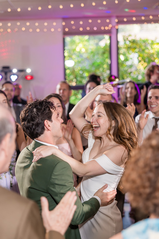 bride and groom at the center of the dance floor