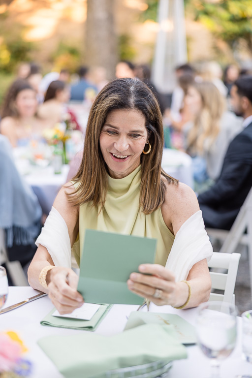 guest reading a handwritten note from the bride and groom