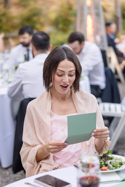a friend reading a note from the bride and groom