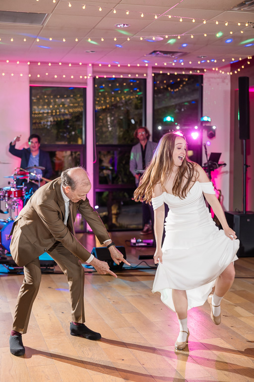 dad pointing out bride's tap-dancing shoes