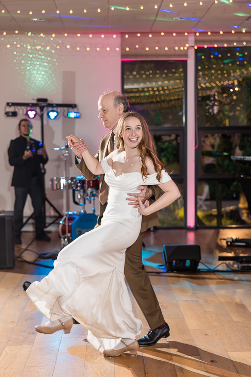dad and bride tap dancing for the crowd