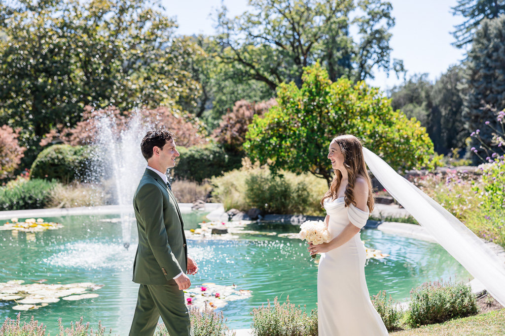 couple walking towards each other in front of a fountain