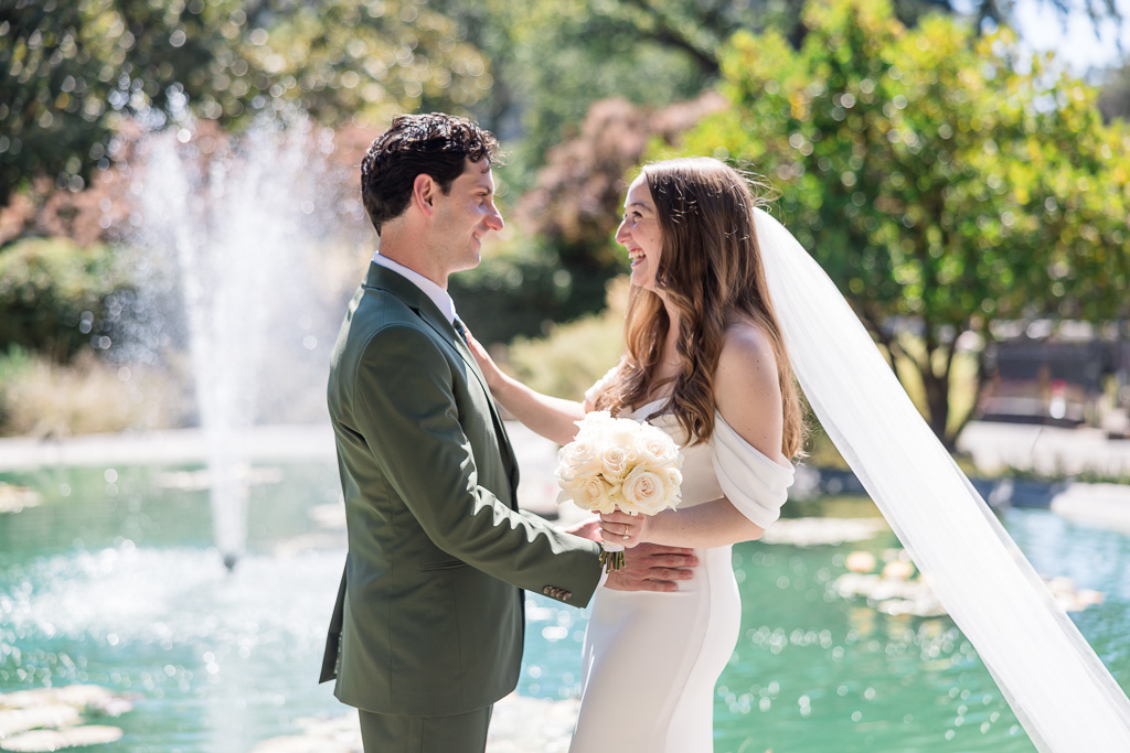 cute wedding photo at a fountain and pond