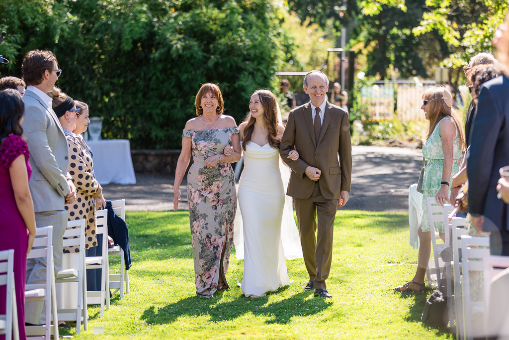 both of bride's parents walking her down the aisle