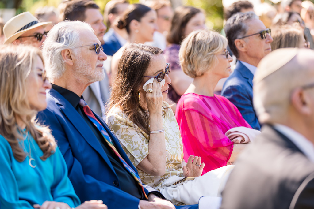 a guest wiping away tears during ceremony