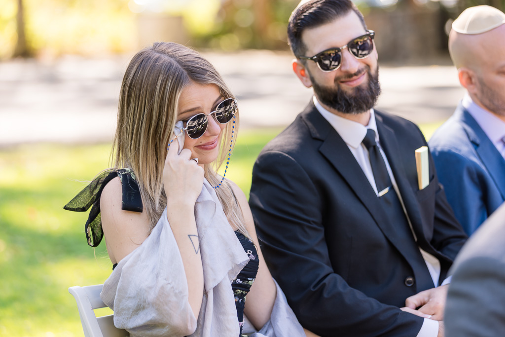 a wedding guest wiping away joyful tears